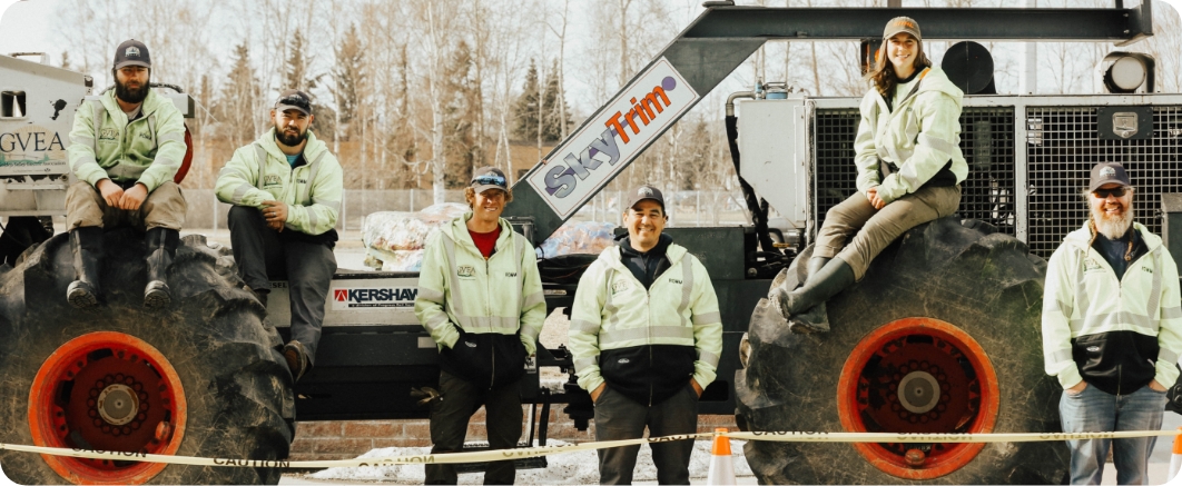 employees stand in an outdoor setting